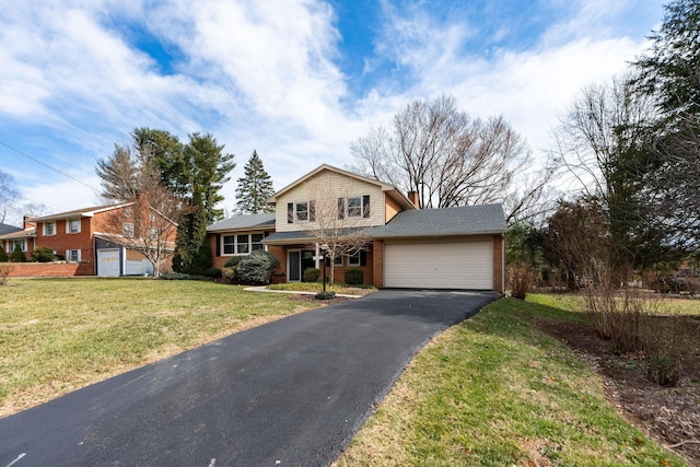 view of front of home with a front lawn, brick siding, an attached garage, and driveway