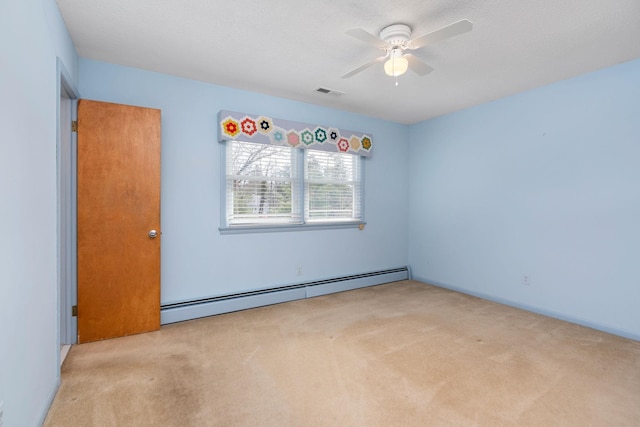 unfurnished room featuring carpet, visible vents, ceiling fan, a textured ceiling, and a baseboard heating unit