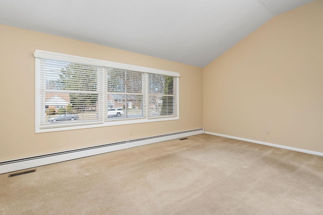 empty room featuring lofted ceiling, carpet, baseboards, and a baseboard radiator