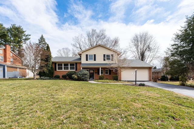 split level home with a garage, a front lawn, brick siding, and driveway