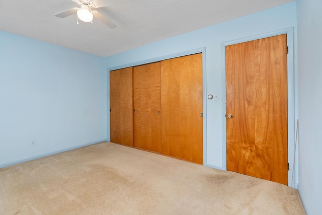 unfurnished bedroom with a closet, baseboards, ceiling fan, and carpet floors