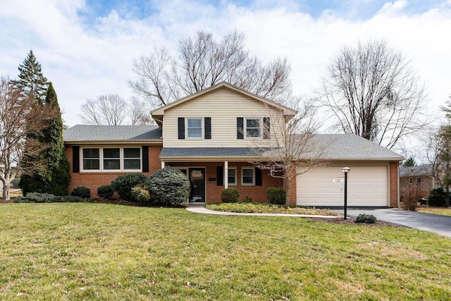 split level home featuring brick siding, a front lawn, roof with shingles, a garage, and driveway