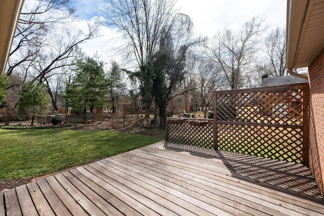 wooden deck featuring a yard