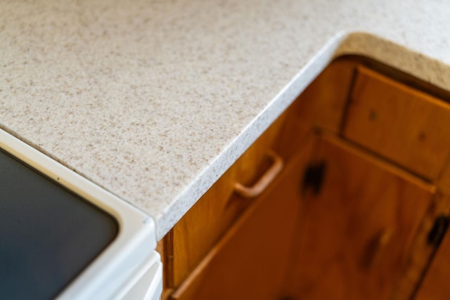 details with brown cabinetry and light countertops