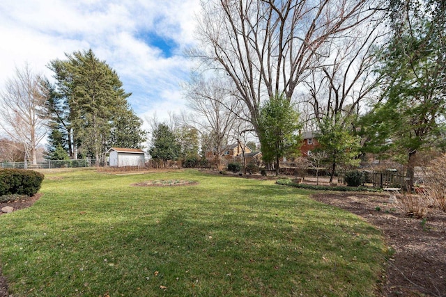 view of yard with an outdoor structure and fence