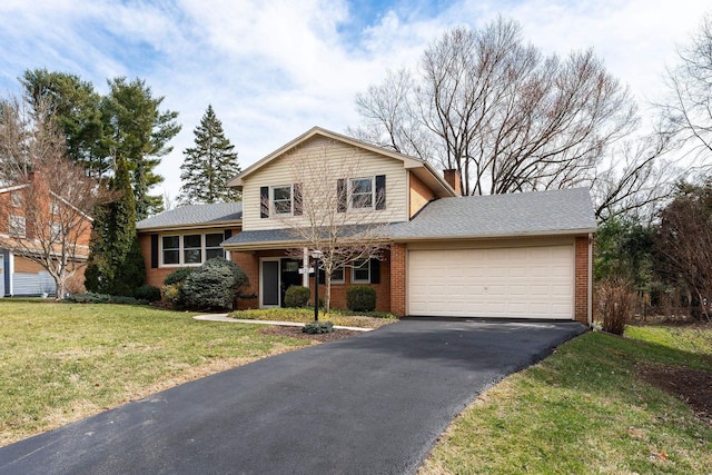 tri-level home featuring a front lawn, aphalt driveway, an attached garage, brick siding, and a chimney