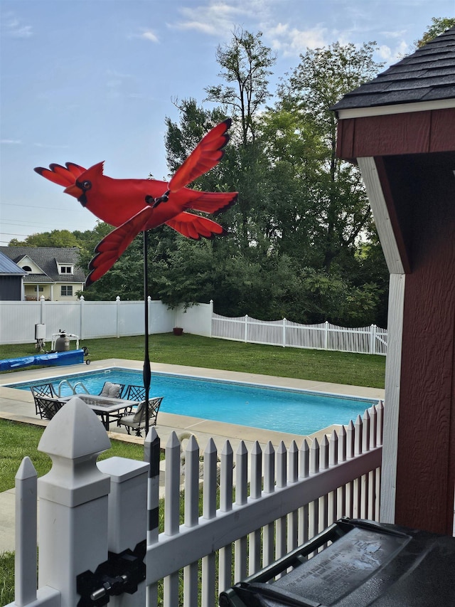 view of swimming pool with a patio area, a fenced backyard, a fenced in pool, and a yard