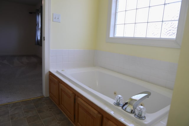 bathroom featuring a tub with jets and tile patterned floors