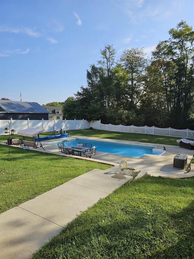 view of pool featuring a yard, a patio area, a fenced backyard, and a fenced in pool