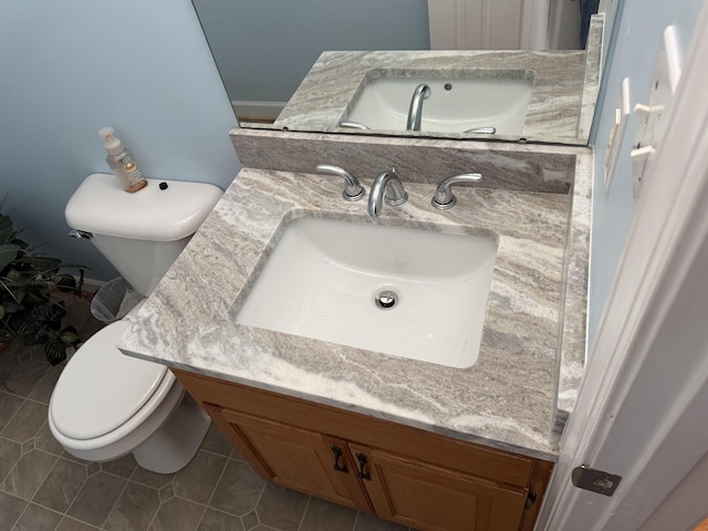 bathroom with vanity, toilet, and tile patterned floors