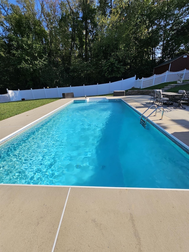 view of pool with a fenced backyard, a fenced in pool, and a patio