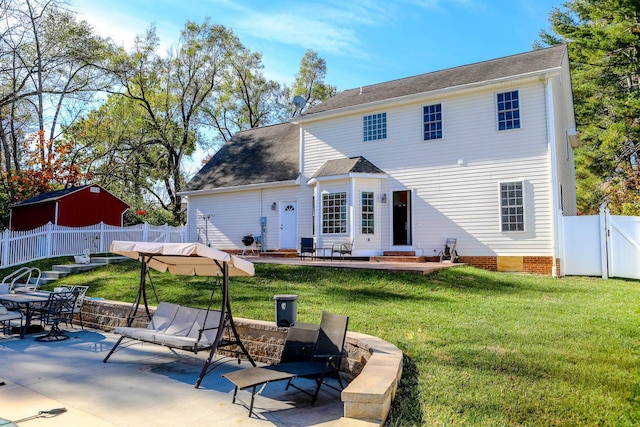 rear view of house featuring a fenced backyard, crawl space, a gate, a yard, and a patio area