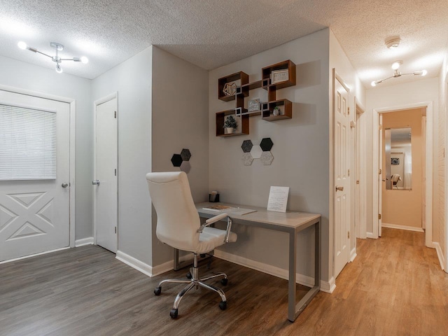 office with a textured ceiling and light hardwood / wood-style floors