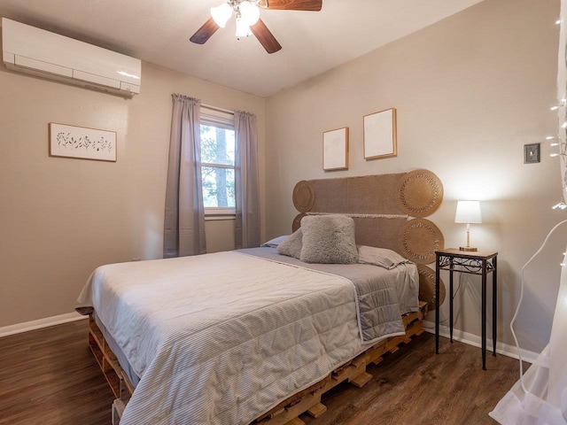 bedroom featuring a wall unit AC, dark hardwood / wood-style floors, and ceiling fan