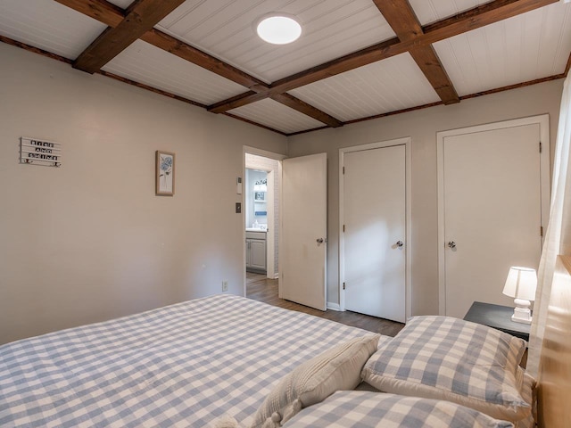 bedroom with beamed ceiling, coffered ceiling, and hardwood / wood-style floors