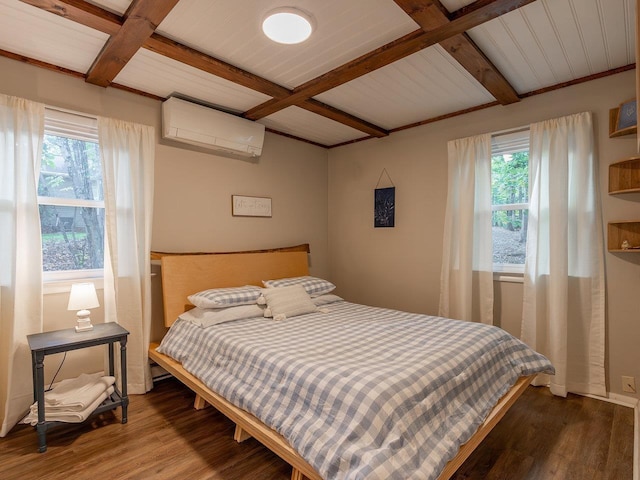 bedroom featuring multiple windows, hardwood / wood-style flooring, beam ceiling, and a wall unit AC