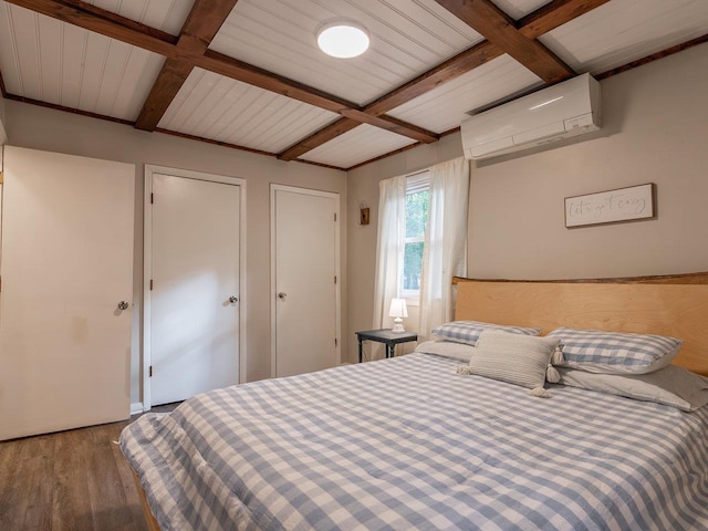 bedroom with hardwood / wood-style floors, beamed ceiling, and a wall mounted AC