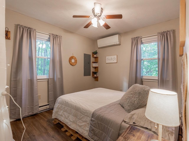 bedroom with multiple windows, dark wood-type flooring, electric panel, and a wall unit AC