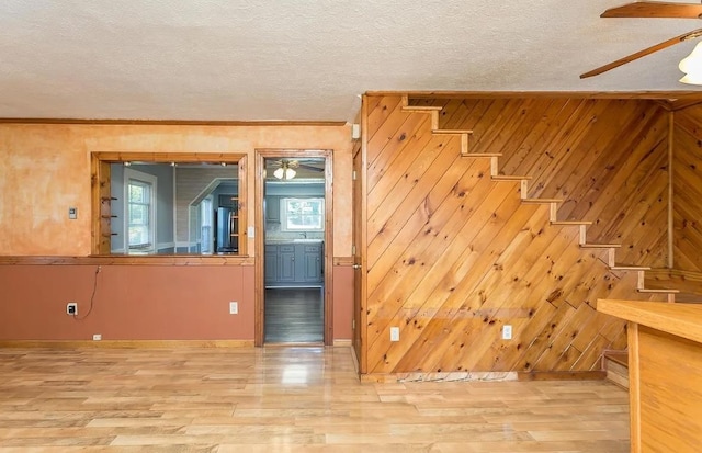 interior space featuring hardwood / wood-style flooring, ceiling fan, and a textured ceiling