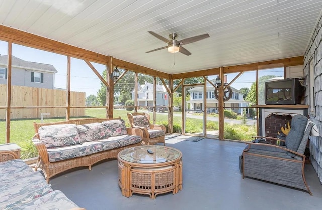 sunroom featuring ceiling fan