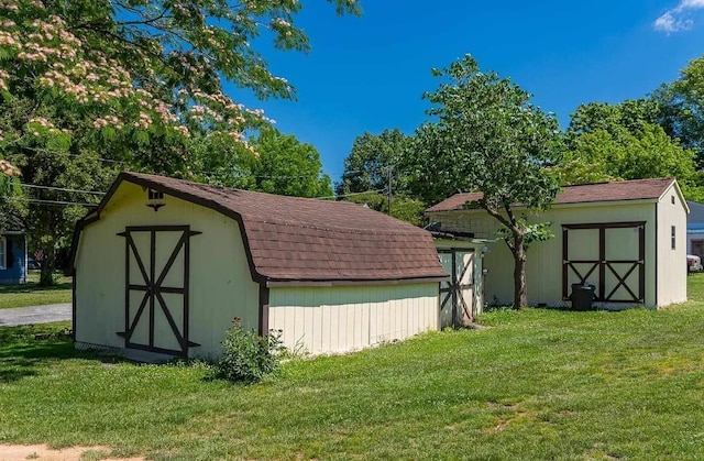 view of outbuilding featuring a yard