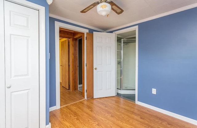 unfurnished bedroom with ceiling fan, ornamental molding, and light wood-type flooring