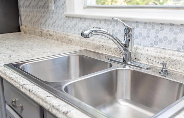 details with light stone countertops and sink