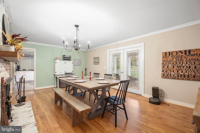 dining room with light wood finished floors, french doors, baseboards, and ornamental molding