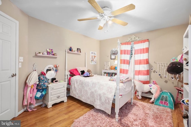 bedroom featuring a ceiling fan and wood finished floors