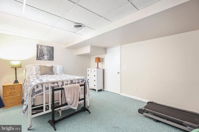 carpeted bedroom with a drop ceiling, visible vents, and baseboards