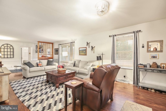 living area with visible vents and wood finished floors