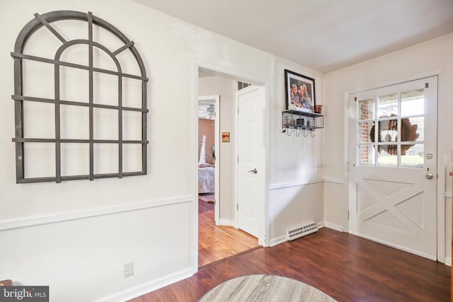 foyer entrance with visible vents, baseboards, and wood finished floors