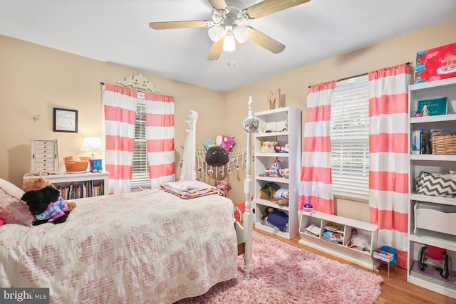 bedroom with ceiling fan and wood finished floors