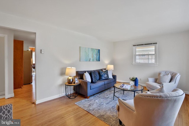 living room with light wood-style flooring and baseboards