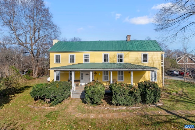 view of front of house featuring covered porch and a front yard