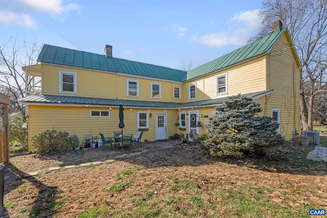 back of property featuring central AC unit