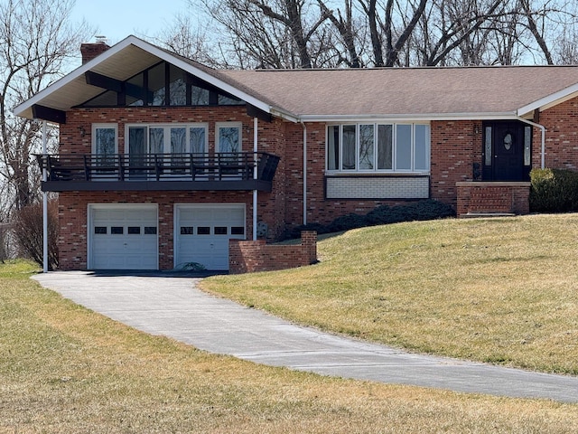 view of front of home with a front yard, brick siding, driveway, and a chimney