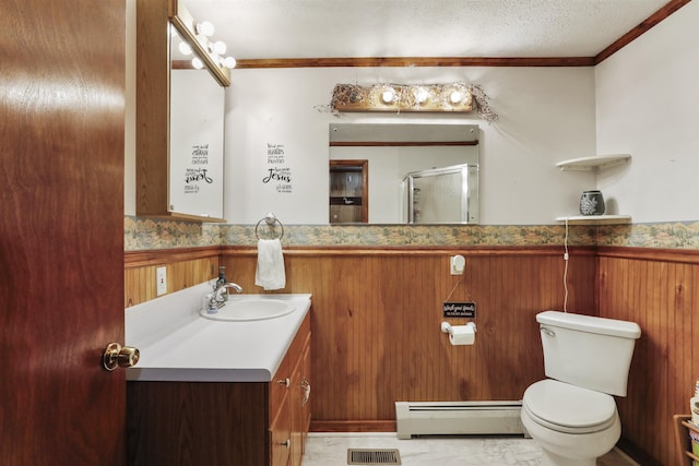 full bathroom featuring toilet, a baseboard heating unit, visible vents, ornamental molding, and a shower with door