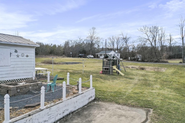 view of yard with a playground, a vegetable garden, and an outdoor structure