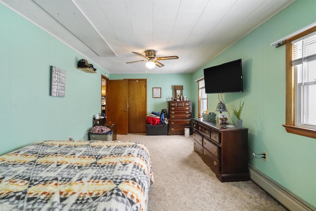 carpeted bedroom with a baseboard radiator, a closet, and ceiling fan