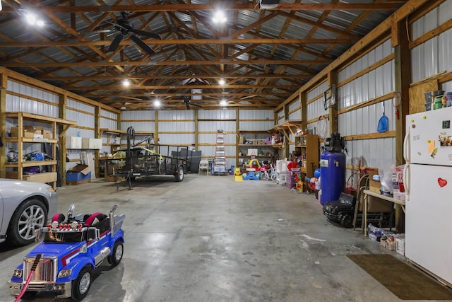 garage with metal wall and freestanding refrigerator