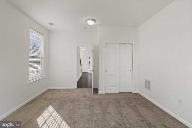 unfurnished room with carpet floors