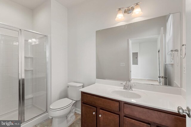 bathroom featuring vanity, toilet, a shower with shower door, and electric panel