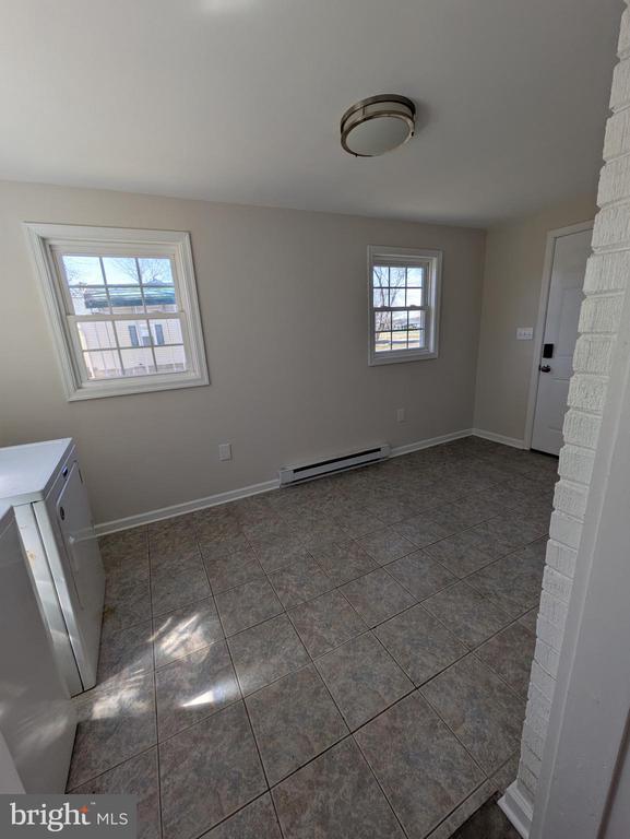 unfurnished living room with visible vents, a fireplace, wood finished floors, and ornamental molding