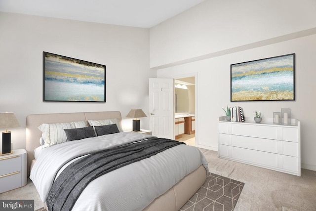 carpeted bedroom featuring connected bathroom and vaulted ceiling