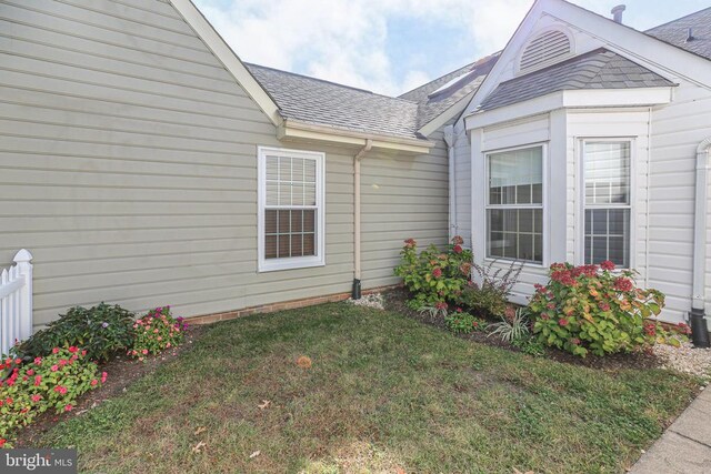 property entrance with a lawn