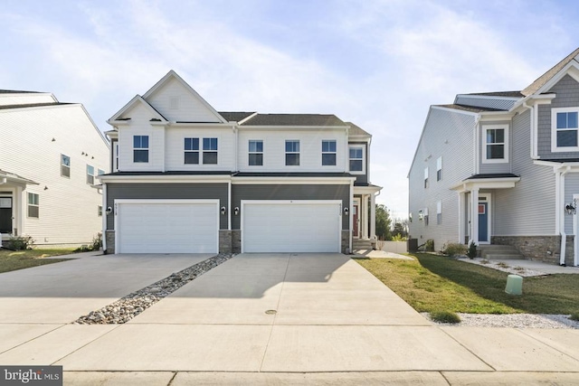 view of front of house with a garage, stone siding, and driveway