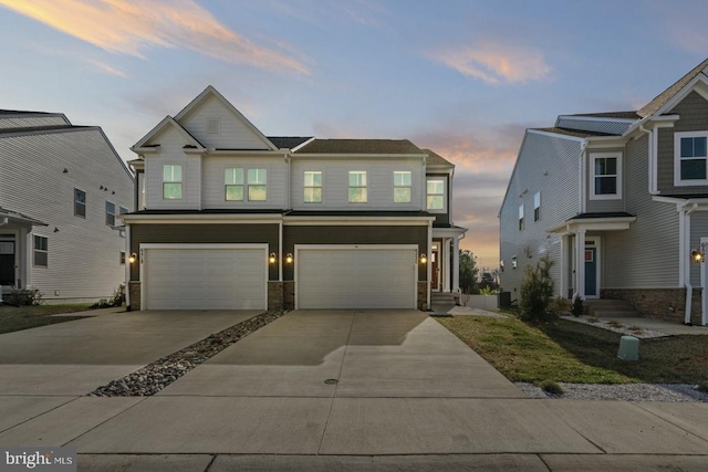 view of front of home featuring stone siding, concrete driveway, and an attached garage