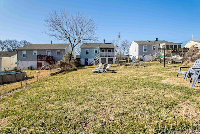 view of yard featuring stairway, a residential view, a wooden deck, and fence