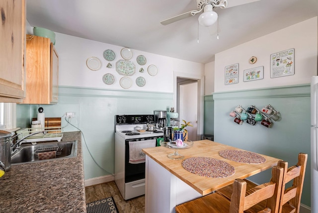 kitchen with range with electric cooktop, a sink, wood counters, wood finished floors, and ceiling fan